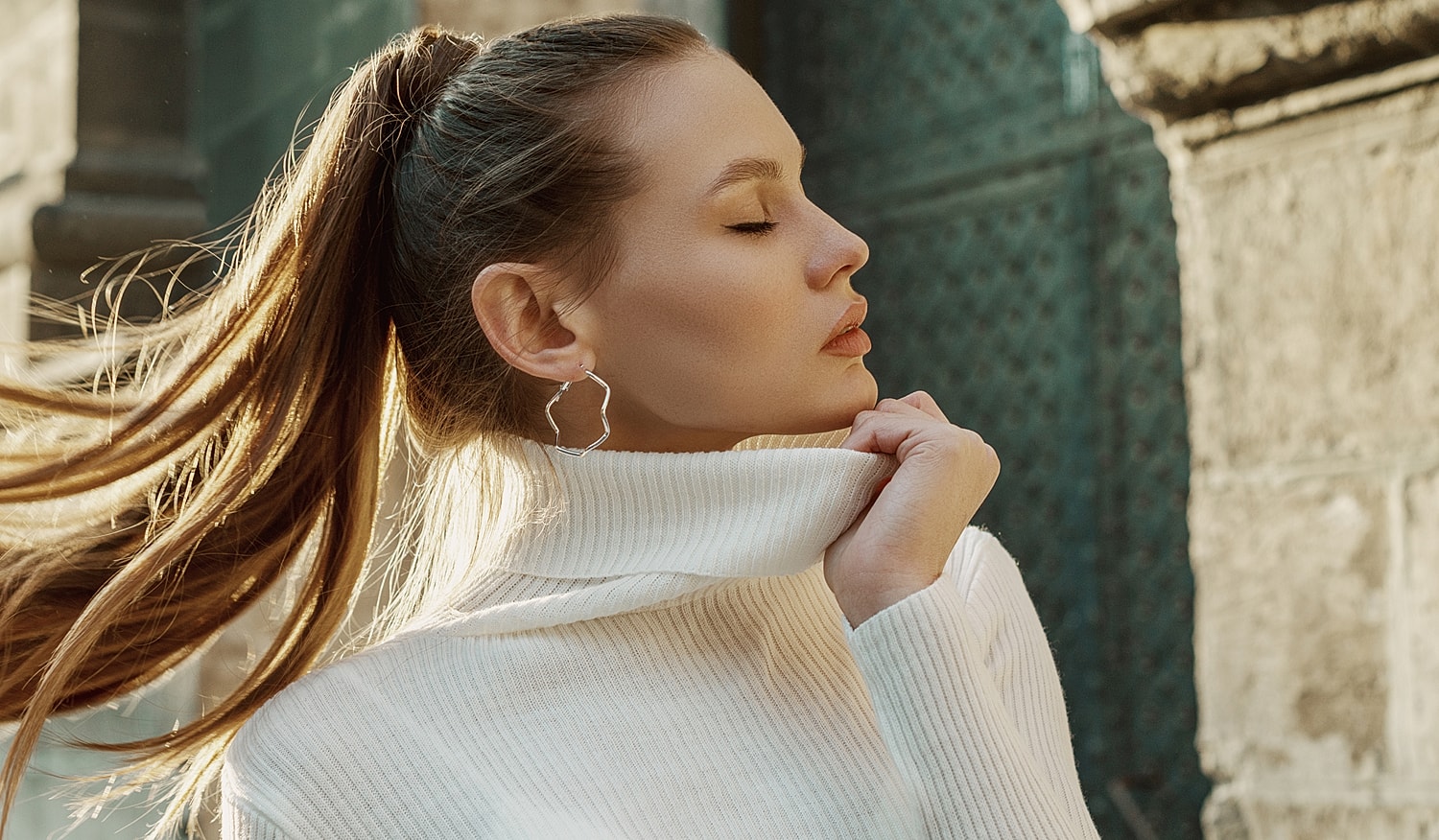 Woman in turtleneck sweater with long hair.