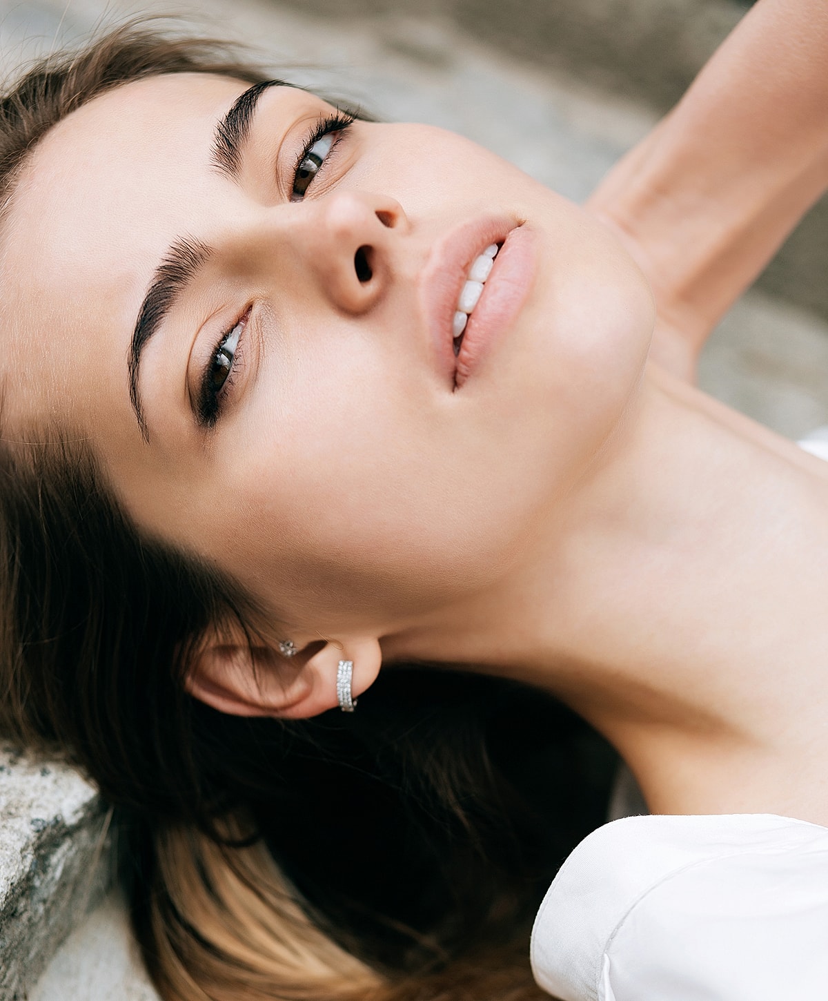 Close-up of a woman with elegant earrings.