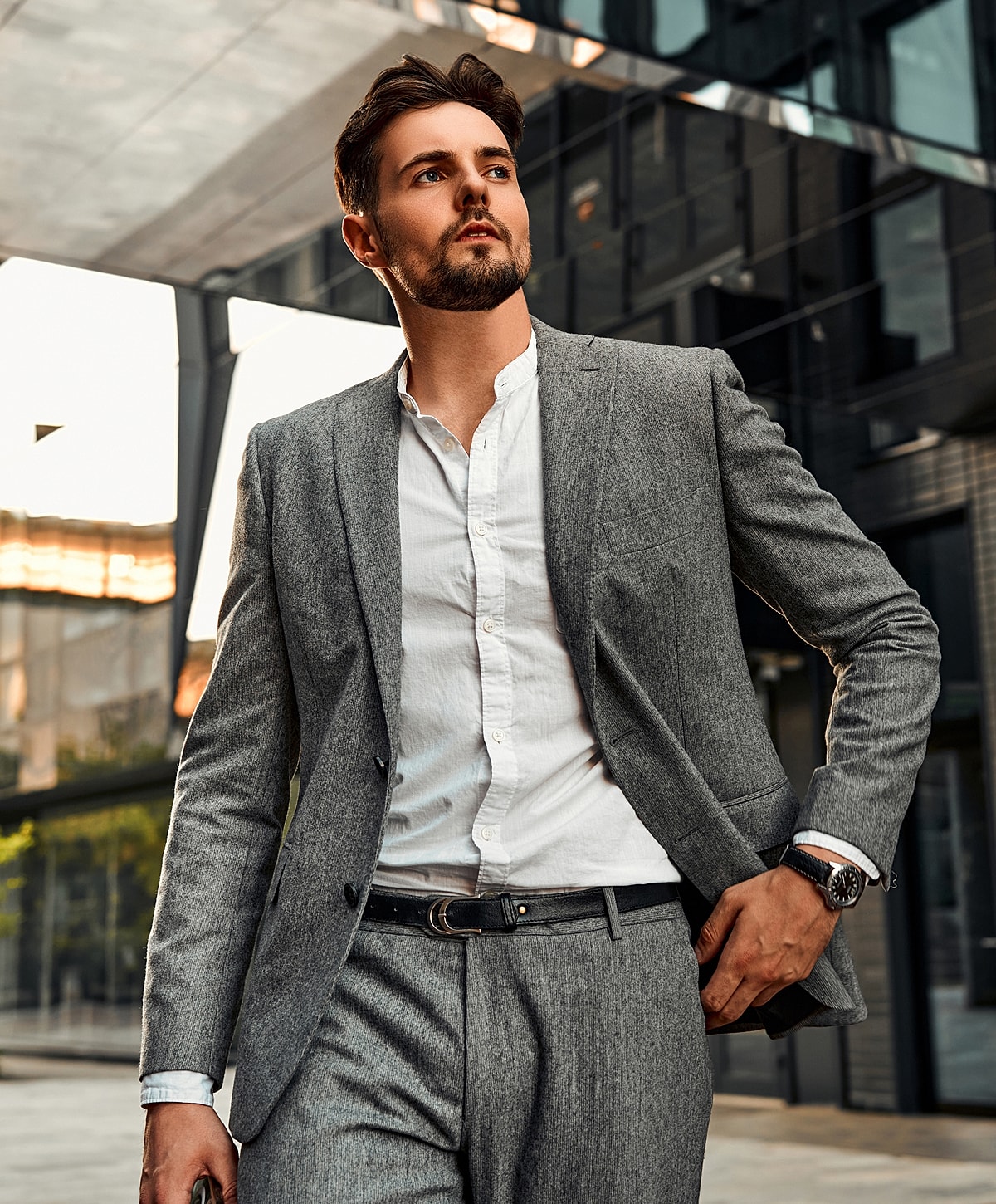 Man in tailored gray suit outdoors.