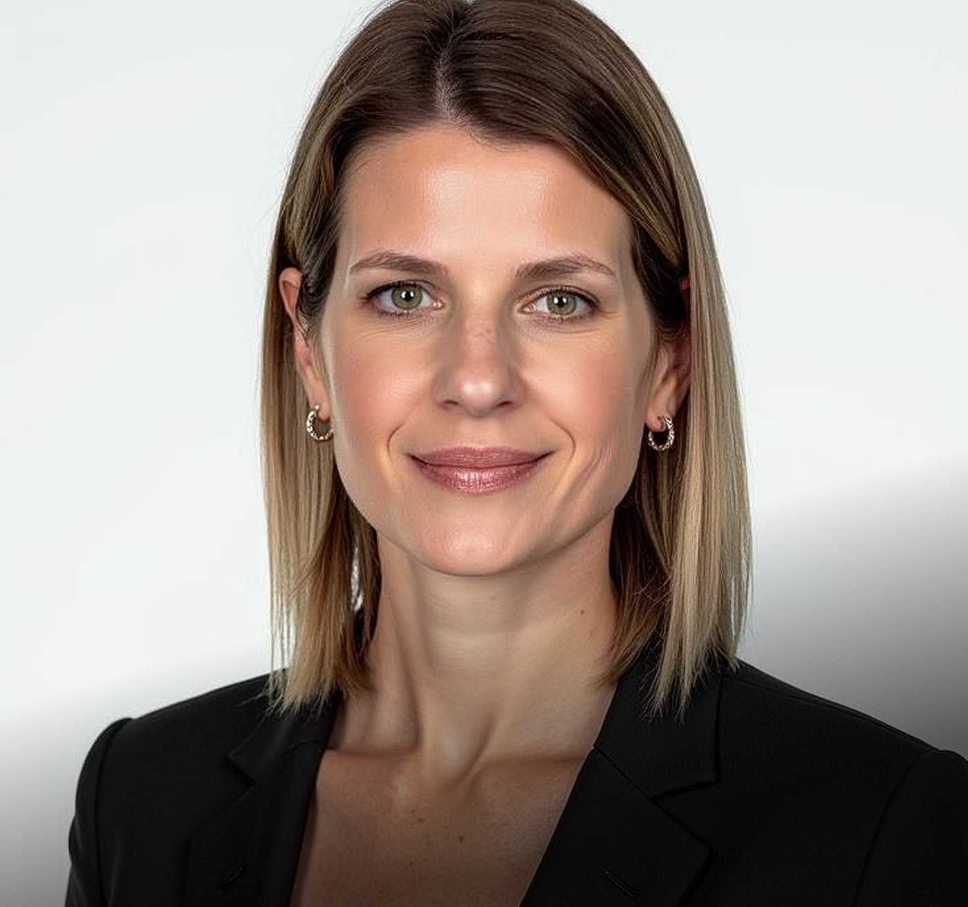Professional woman smiling in a black blazer.