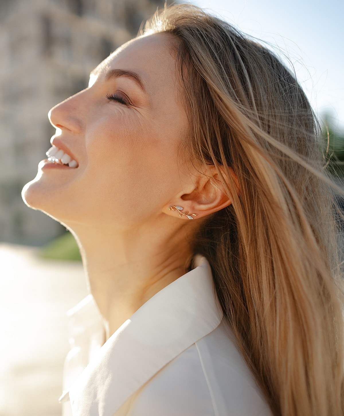 Woman with long hair in neutral-toned outfit.