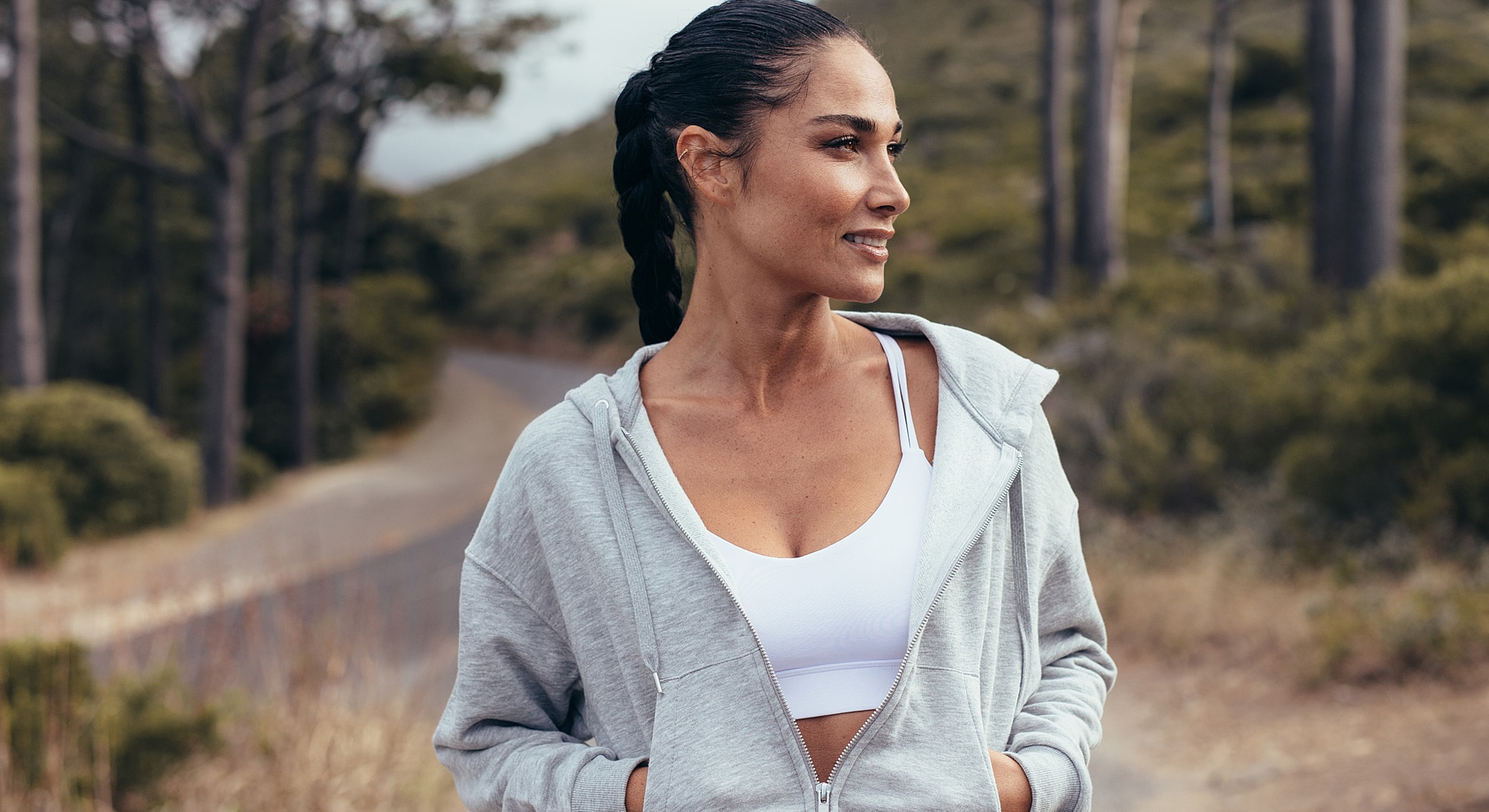 Woman in athletic wear enjoying outdoor scenery.